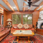 Stunning southwestern living area with a burning kivia luxury vacation rentals Santa Fe, Fort Macy