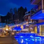 Outdoor hot tub & pool under the night sky at the luxurious Grand Colorado on Peak 8